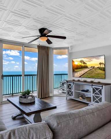 Balcony with Adirondack chairs overlooking palm trees and the Atlantic Ocean